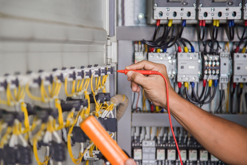 Electrical,engineer,checking,the,operation,of,electrical,control,cabinet,,maintenance
