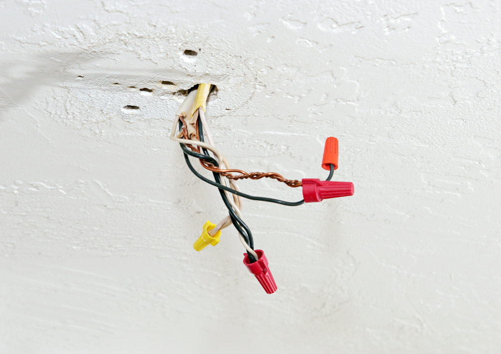 Exposed,wires,with,wire Nuts,,dangling,from,a,hole,in,the