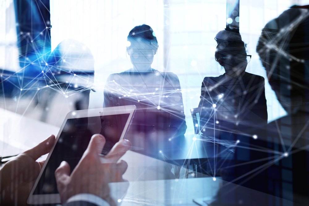 Business,man,works,in,office,with,tablet,in,the,foreground.